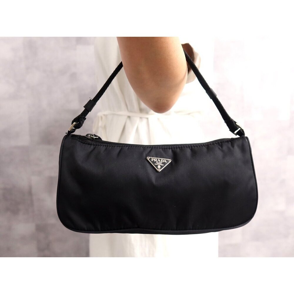 PRADA Triangle plate Pocono Clutch handbag Black on the arm